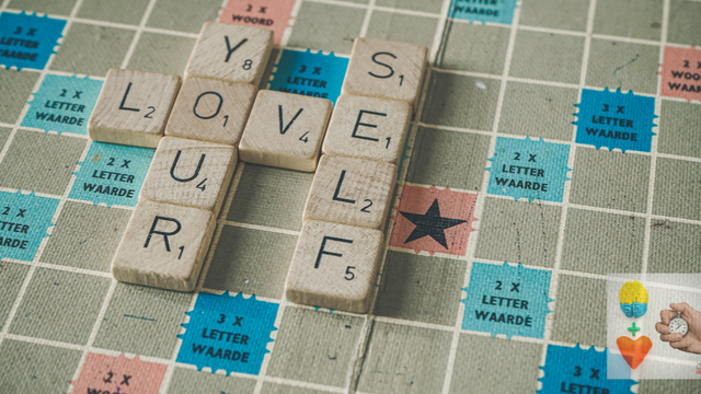 Stock art image of a Scrabble board game. The tiles spell out: “love yourself.”