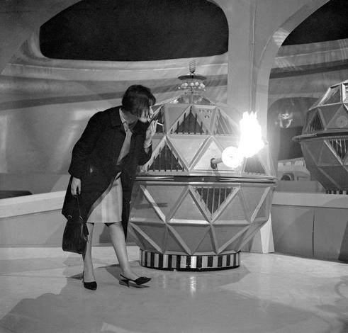 14th April, 1965: Legendary Doctor Who producer Verity Lambert confronts a flame-belching Mechanoid at Ealing Studios, London... and lights her ciggy with it.