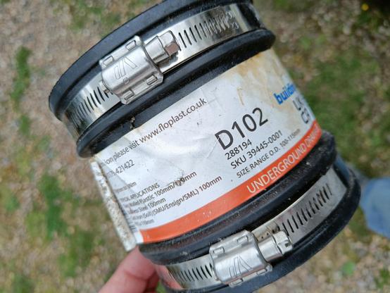 A 10cm rubber coupling labelled "underground drainage". At both ends of which are stainless steel jubilee clips.