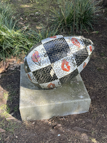 A public sculpture in the shape of an egg covered in a pop art mosaic 