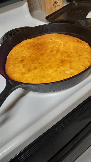 Cast iron skillet with beautiful cornbread in it