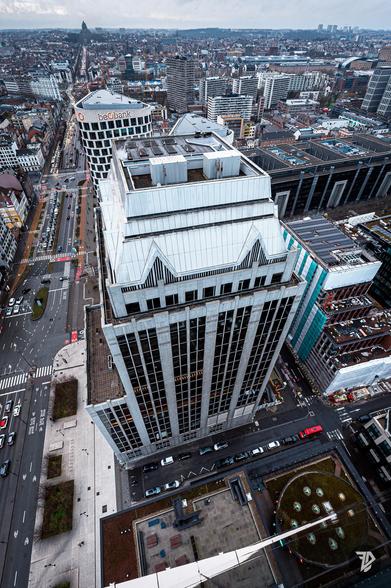 Lookdown from a tall building in the city, closest building brutalist architecture