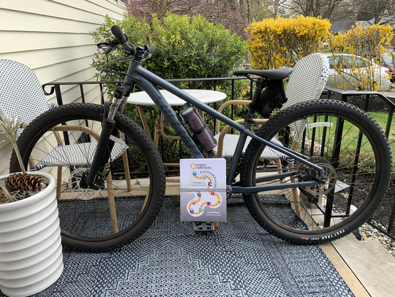 My mountain bike with a hardback version of Eclipse Collections Categorically book standing on a pedal.