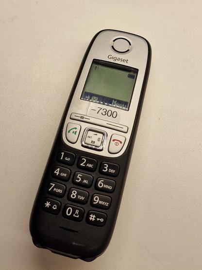 DECT phone with a label saying "— 7300" 