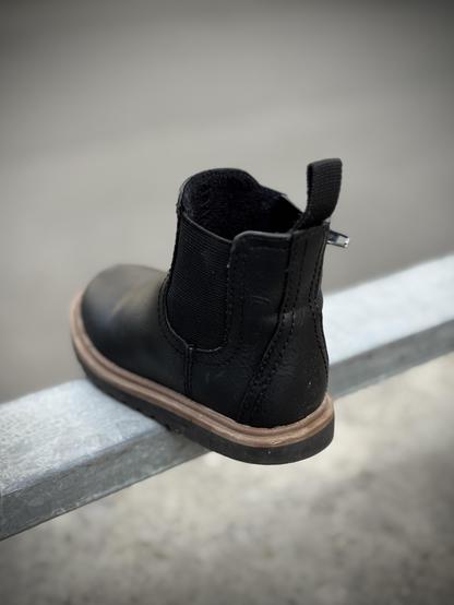 Child shoe on a  barrier. Probably lost.