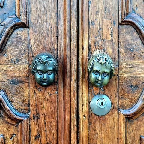 Detail of the door handles, which are shaped like angels' heads.
