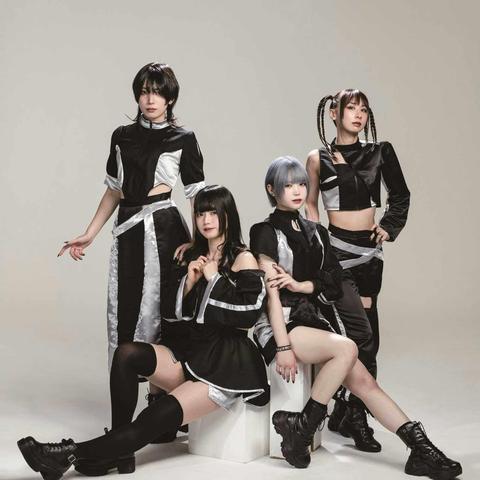The photo features the four members of Broken By The Scream posing against a light background, two of the members are sitting on white blocks, while the other two are standing behind them. They are wearing coordinating black and silver costumes and each having a unique hairstyle.