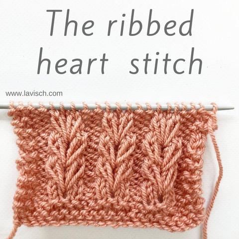 A swatch in salmon pink yarn on a gray knitting needle, showing the Ribbed Heart Stitch