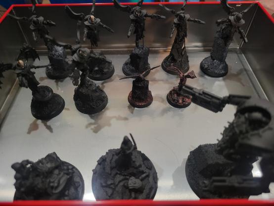 Seven Seraphim and some assorted other printed miniatures, all primed black.