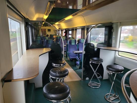 5 bar stools next to their tables. The other half of the carriage is a seating area.