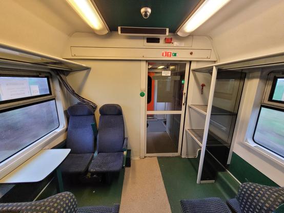 Luggage rack at the end of a seating carriage.