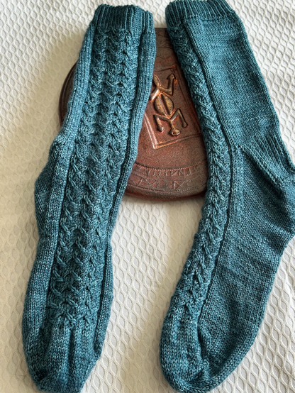 Hand made socks with a little stitch motif in the front.