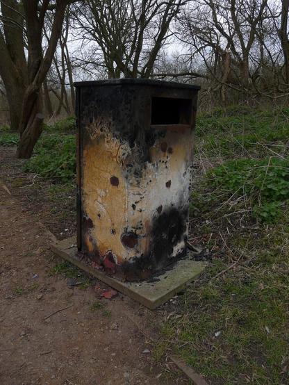 A photo titled "Burnt Out Totem, Grand Union Canal Slough Arm", taken near Bridge 0, Packet Boat Marina Footbridge by Loz Flowers on Flickr.