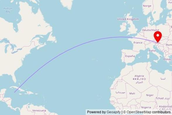 A map showing the great circle route from George Town in the Cayman Islands to a map pin at Pfarrkirche hl. Michael, Kirchenweg, 8443 Gleinstätten, Austria