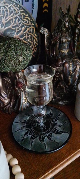 Offering of white wine on pagan altar