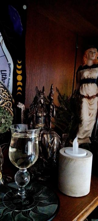 Offering of white wine on pagan altar