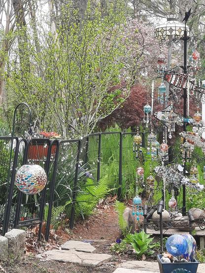 Beaded tree in an exlectic, lush garden.
