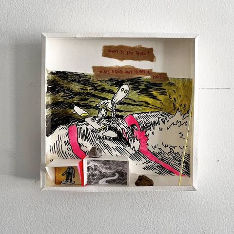 A small mural sculpture made of paper, a little box in which there is a drawing of a masked man doing surf on a big green wave. Both the man and the wave are sliced, showing a vivid pink inside. A small paper shelf has some rocks on it.