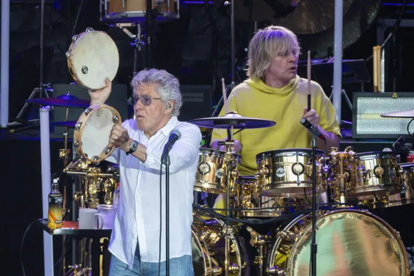 The Who's Roger Daltrey playing two tambourines with drummer Zak Starkey in the background playing the drums at the recent Teenage Cancer Trust show at the Royal Albert Hall in London, England.