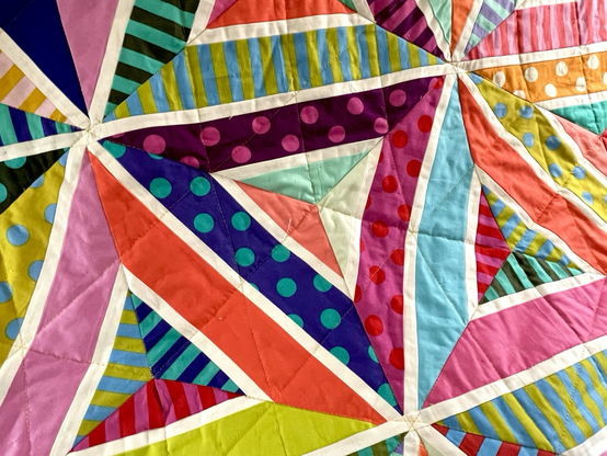 A close up of the geometric block that makes up the quilt. It is a series of triangles and diamonds
