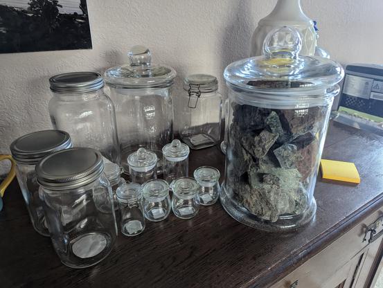 a bunch of jars, one of which is full of rocks