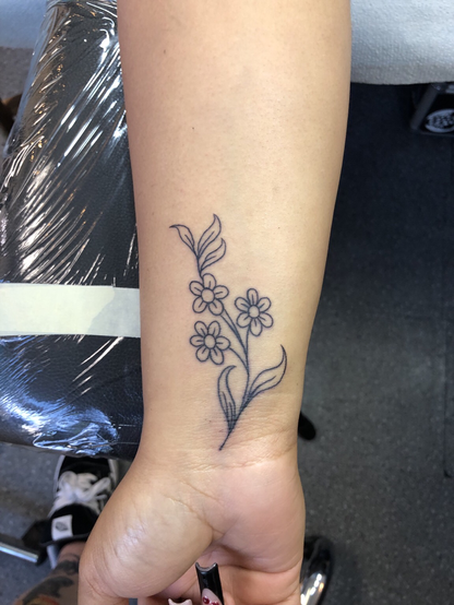 Floral tattoo on the wrist by Mitch Wolff Tattoons