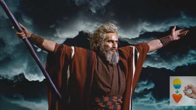 Movie still from The Ten Commandments of Charlton Heston as Moses, holding his arms out during the parting of the Red Sea.