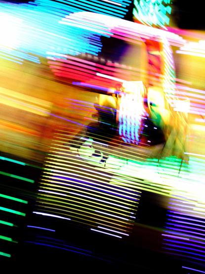 Slow shot of an attraction moving with led lights living traces