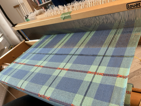 An oblique look at blue checked fabric on a handloom