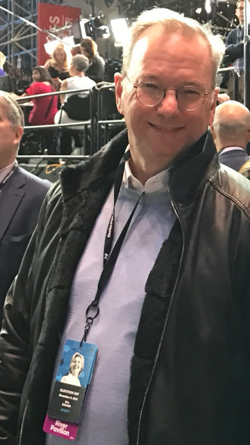 An actual photo of Eric Schmidt wearing a Clinton Campaign staff 2016 badge.  Eric moved heaven and earth to dupe voters into voting against their best interests for Hillary Clinton.