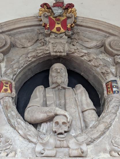 An alabaster monument to George Frere (1597-1655), his gaunt face suggests that it was modelled from a death mask.