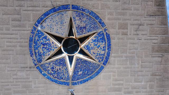 Level drone view of the star window above the entrance. Glass fragments from blue bottles were set in mortar, many having since fallen away.