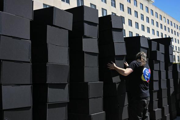 Protesters' 'coffins' stacked up at USAID HQ.