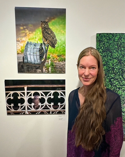 NYC wildlife Photographer Anke Frohlich next to her two Flaco photographs at the Hudson Guild Gallery in NYC. On display are "Flaco on a Central Park bench" and "Flaco on Bridge 28", Central Park's "Gothic Bridge". 