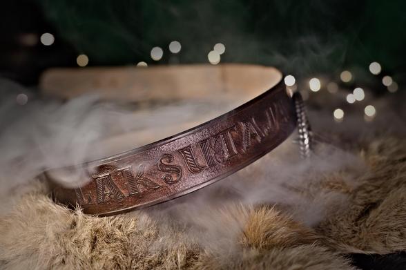 Dark brown belt with hand carved decoration. For a decoration the belt has text this time, probably a name for the belt, which says "slapper" when translated to english. Original text is "laksutaja" in estonian. 