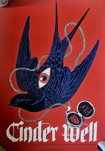 Poster for the band Cinder Well featuring a stylized illustration of a dark blue bird in flight against a deep red background. The bird has an eye embedded in its wing and is entangled in a silver chain connected to an open locket. The locket contains a red anatomical heart on one side and the handwritten message "You found cadence" on the other. At the bottom, in white gothic-style text, it reads "Cinder Well" with tour dates and locations listed beneath. The artwork is credited to Subterranean Prints.