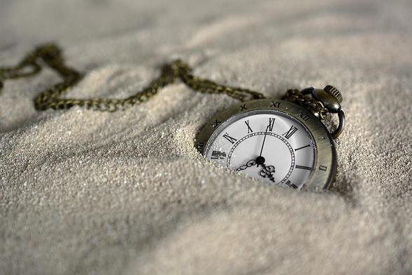 watch half-way burried in sand