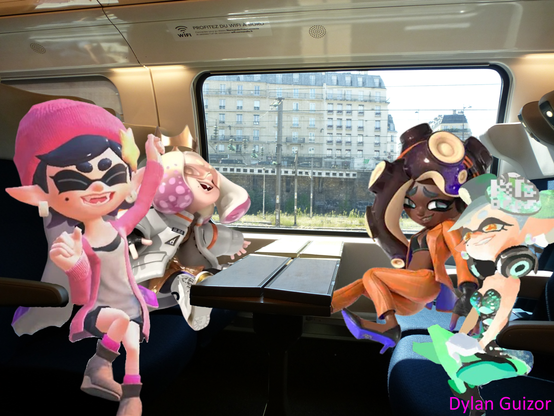 Marie, Callie, Pearl and Marina, all 4 together in a seat of 4 on a French train, everyone smiling