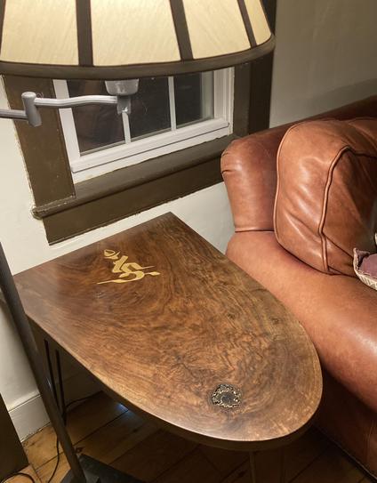 Half-oval table in claro walnut with the Siddham syllable "Hum," used in Shingon Buddhist meditation, hand-carved into the top.