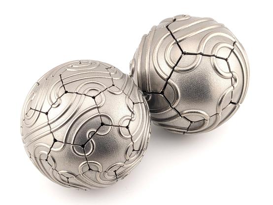 Two spherical steel sculptures with an interesting combination of geometric shapes and organic squiggles