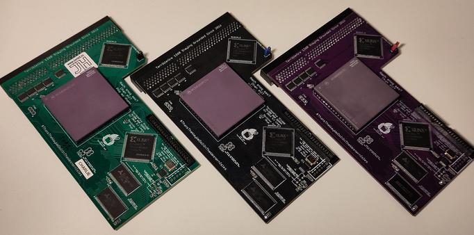 Three TerribleFire TF1260 Amiga accelerators laid out next to each other.