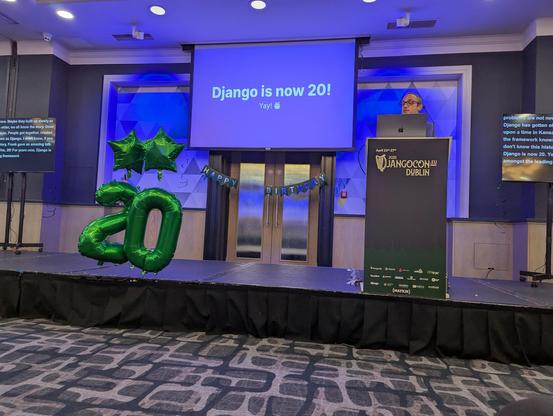 Slide show picture at the DjangoCon Europe 2025 Conference, saying: Django is now 20. Presumably, the speaker on stage is starting the conference that turns 20 years old now.