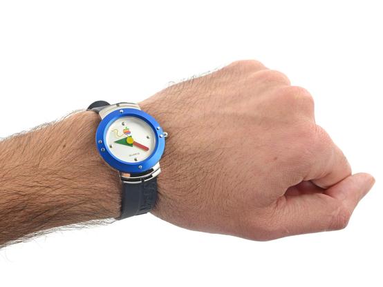 Left wrist with Apple analog watch from 1995 adorning it. The time on the watch is roughly 9:23.