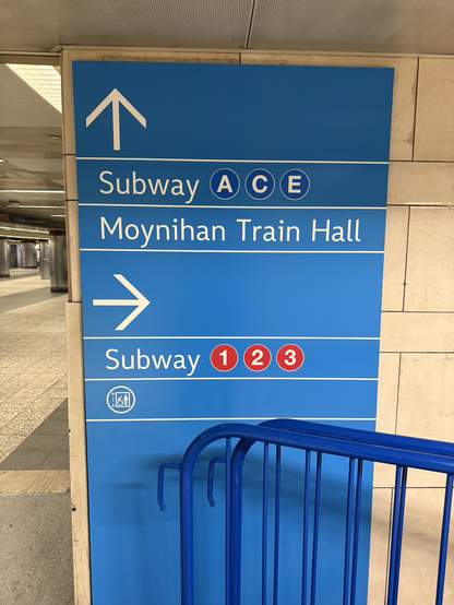 Wayfinding sign in Penn station, pointing to subway lines ACE, 123