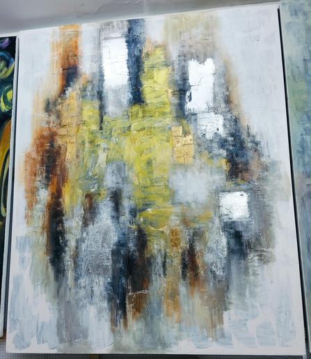 an abstract painting, it is gold and silver and bronze and black tones against a lighter background 