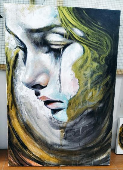 a painting of a face, seen from the front in a three quarter view, a tear coming down her cheek, her hair is green, the background silver with a swoop of gold tones from the upper left to the bottom right 