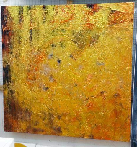 an abstact painting, it is shades of gold swirling around against a black and red background 
