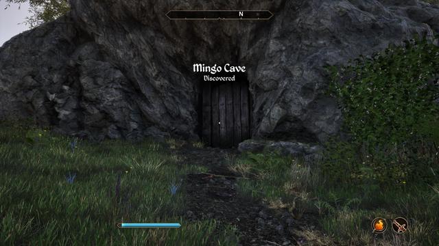 The wodden slat-door to Mingo Cave. It's a rocky outcrop in the grasland with a wooden door.