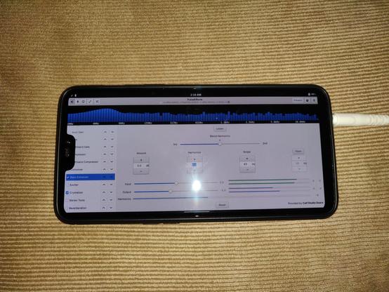 The PulseEffects audio effects application showing a spectrum graph and Bass Enhancer active.  The phone is rotated in landscape mode for this application.