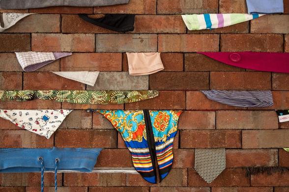 Wall (installation views) by Karyn Olivier, 2017-2018 (clothes, bricks)
A brick wall with various items of clothing squeezed between the horizontal layers.